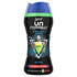 A bottle of Lenor Unstopables In-Wash Scent Booster, with a predominantly black design and blue cap. The product is recommended by Ariel and has an illustration of a person playing tennis on the label.